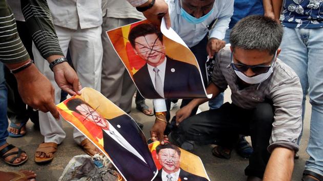 Supporters of India's ruling Bharatiya Jayanta Party (BJP) burn defaced posters of Chinese President Xi Jinping during a protest against China, in Ahmedabad, India.(REUTERS)