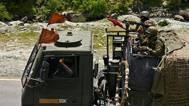 Indian army soldiers ride in a convoy along a highway leading towards Leh, bordering China, in Gagangir on June 17, 2020.(AFP)