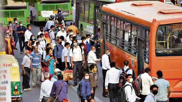 Commuters flout social distancing as they rush to board a bus at ITO. (Raj K Raj/HT photo) Commuters flout social distancing as they rush to board a bus at ITO. (Raj K Raj/HT photo)