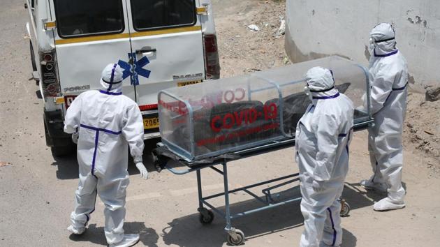 The Covid-19 victim being taken to the cremation site by his son and two nephews who died of dehydration there on Thursday. (HT File) The Covid-19 victim being taken to the cremation site by his son and two nephews who died of dehydration there on Thursday. (HT File)