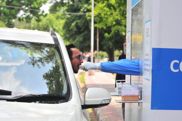A man being testing for Covid 19 in a drive-through booth installed by a private laboratory at Sector 11, Chandigarh.(Ravi Kumar/HT)