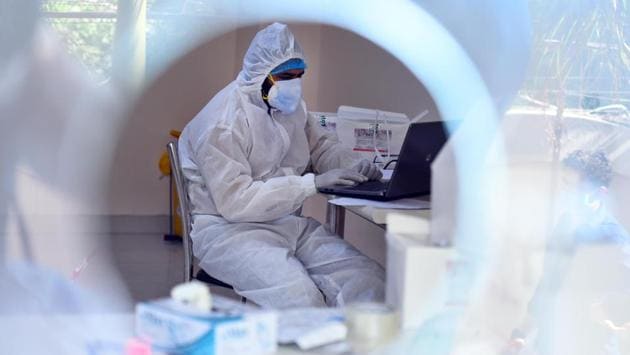 A medical technician at work in a sample collection centre in West Vinod Nagar on June 18. Rapid antigen testing was done at 193 centres in Delhi on June 18. A total of 7,040 people were tested of whom 456 tested positive for the infection, acting health minister Manish Sisodia said in a tweet yesterday. Testing is initially being done in containment zones. (Raj K Raj / HT Photo)