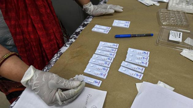 A technician works with antigen test kits in Dilshad Garden on June 18. “The sensitivity of this test and that of RT-PCR is almost similar; the sensitivity of RT-PCR is about 67%. But, the antigen test is faster and cheaper, so we can test more people. This means that we will be able to detect more cases at an early stage,” Dr Jugal Kishore, head of the department of community medicine at Safdarjung hospital told HT. (Biplov Bhuyan / HT Photo)