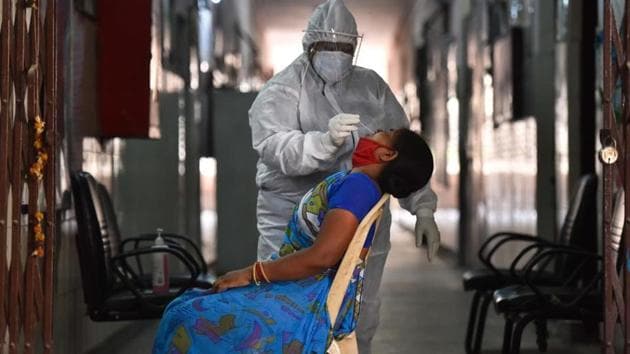 A woman gives a nasopharyngeal swab for a Covid-19 antigen test at a testing centre in New Delhi.(SANCHIT KHANNA/HT PHOTO.)