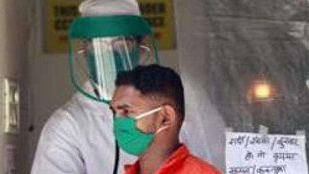 A medical staff checks a person at the Covid-19 testing centre during a testing camp in Mumbai on Friday. (ANI PHOTO.) A medical staff checks a person at the Covid-19 testing centre during a testing camp in Mumbai on Friday. (ANI PHOTO.)