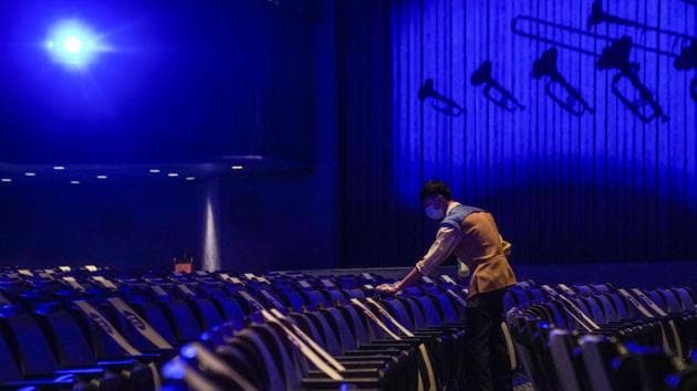 An employee cleans seats between showings of the Mickey’s PhilharMagic show in Fantasyland at Walt Disney Co.'s Disneyland Resort in Hong Kong, China. (Bloomberg) An employee cleans seats between showings of the Mickey’s PhilharMagic show in Fantasyland at Walt Disney Co.'s Disneyland Resort in Hong Kong, China. (Bloomberg)