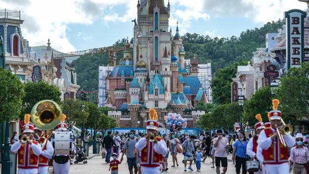 A marching ban plays as visitors walk past the Castle of Magical Dreams under construction at Walt Disney Co.'s Disneyland Resort in Hong Kong. (Bloomberg) A marching ban plays as visitors walk past the Castle of Magical Dreams under construction at Walt Disney Co.'s Disneyland Resort in Hong Kong. (Bloomberg)