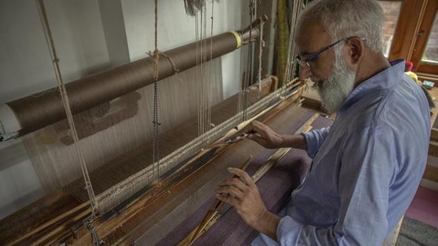 Gulzar Ahmed Want, a Kashmiri artisan, weaves a pashmina shawl on a loom inside his home in Srinagar, Indian controlled Kashmir. (AP)