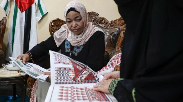 Um Zeid, 47 year-old, and Khawla 48 year-old, Palestinian refugees women living in Jordan embroider a traditional Palestinian dresses for customers at Al-Baqaa Palestinian refugee camp, near Amman, Jordan, June 16, 2020. Picture taken June 16, 2020. (REUTERS)