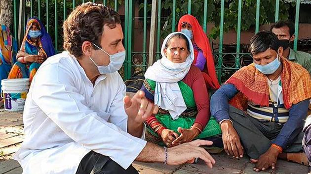 Former Congress president Rahul Gandhi interacts with migrant labourers who were walking on the Sukhdev Vihar flyover to reach their native places, amid ongoing Covid-19 lockdown, in New Delhi.(PTI File)
