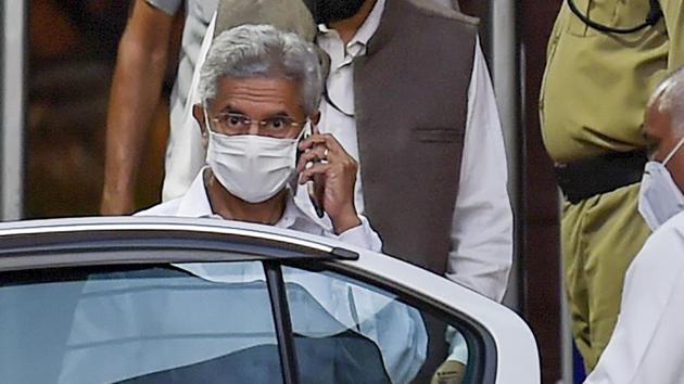 External Affairs Minister S Jaishankar talks on phone as he leaves the building, at South Block in New Delhi.(PTI)