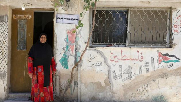 Um Nayef, 74 year-old Palestinian refugee woman living in Jordan, wears the traditional Palestinian dress as she poses in front of her home at Al-Baqaa Palestinian refugee camp, near Amman, Jordan, June 16, 2020. (REUTERS)