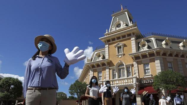 Employees wearing face masks to prevent the spread of the new coronavirus, welcome visitors at the Hong Kong Disneyland. (AP) Employees wearing face masks to prevent the spread of the new coronavirus, welcome visitors at the Hong Kong Disneyland. (AP)