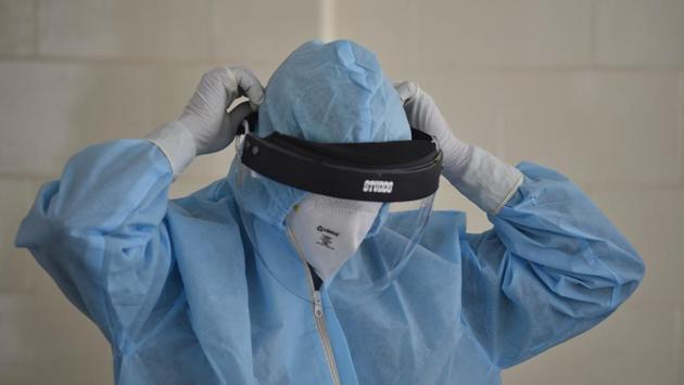 A health worker puts on a PPE kit before collecting samples to test for Covid-19 infection at a dispensary in Mehrauli, New Delhi on June 19. The number of coronavirus disease (Covid-19) cases in Delhi crossed the 50,000-mark on June 19, with 3,137 new cases--the highest in a single day. (Sanjeev Verma / HT Photo) A health worker puts on a PPE kit before collecting samples to test for Covid-19 infection at a dispensary in Mehrauli, New Delhi on June 19. The number of coronavirus disease (Covid-19) cases in Delhi crossed the 50,000-mark on June 19, with 3,137 new cases--the highest in a single day. (Sanjeev Verma / HT Photo)