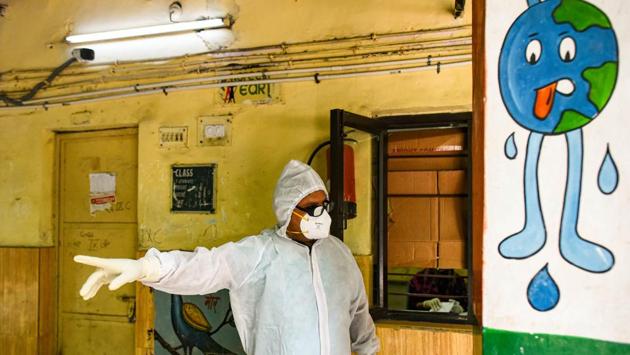A health worker wearing PPE coveralls gestures while collecting samples at a temporary COVID-19 testing centre in SKV Government Girls Senior Secondary School, New Delhi. With 53,116 cases and 2,035 deaths, Delhi’s current case fatality rate stands at 3.8%. (Amal KS / HT Photo) A health worker wearing PPE coveralls gestures while collecting samples at a temporary COVID-19 testing centre in SKV Government Girls Senior Secondary School, New Delhi. With 53,116 cases and 2,035 deaths, Delhi’s current case fatality rate stands at 3.8%. (Amal KS / HT Photo)