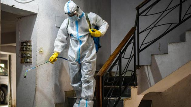 A MCD worker sprays disinfectant inside a residential building in the Arjun Nagar containment zone. Delhi recorded its first case of the infectious disease on March 2, when a Mayur Vihar resident tested positive for the infection after returning from Italy. (Amal KS / HT Photo) A MCD worker sprays disinfectant inside a residential building in the Arjun Nagar containment zone. Delhi recorded its first case of the infectious disease on March 2, when a Mayur Vihar resident tested positive for the infection after returning from Italy. (Amal KS / HT Photo)