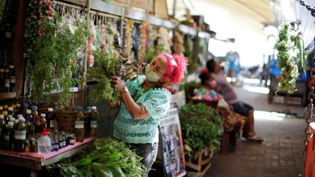 Beth Cheirosinha works in the sale of the Amazonian herbal remedies at the river market Ver-o-Peso in Belem on June 16. Public health experts have warned that loosening restrictions too soon threatens to accelerate contagion and drive up fatalities. Even regions once considered examples of successful efforts against the virus are now struggling. (Ueslei Marcelino / REUTERS) Beth Cheirosinha works in the sale of the Amazonian herbal remedies at the river market Ver-o-Peso in Belem on June 16. Public health experts have warned that loosening restrictions too soon threatens to accelerate contagion and drive up fatalities. Even regions once considered examples of successful efforts against the virus are now struggling. (Ueslei Marcelino / REUTERS)
