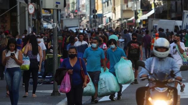 People walk with bags at a popular shopping street amid the coronavirus disease (Covid-19) outbreak, in Sao Paulo, Brazil on June 19, 2020.(Reuters File Photo) People walk with bags at a popular shopping street amid the coronavirus disease (Covid-19) outbreak, in Sao Paulo, Brazil on June 19, 2020.(Reuters File Photo)