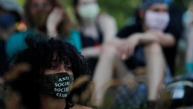 A woman wearing an "Anti Social Social Club" mask listens to the speakers during a "Funk the Police - Juneteenth Edition" rally (REUTERS) A woman wearing an "Anti Social Social Club" mask listens to the speakers during a "Funk the Police - Juneteenth Edition" rally (REUTERS)