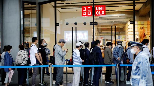 People wearing masks stand in a line to enter Uniqlo's newly launched shop in Tokyo, Japan on June 19, 2020.(Reuters Photo)