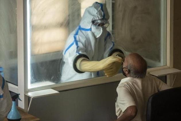 A health worker collects a swab sample from a man to test for Covid-19, Pune, June 19, 2020 (Pratham Gokhale / Hindustan Times)