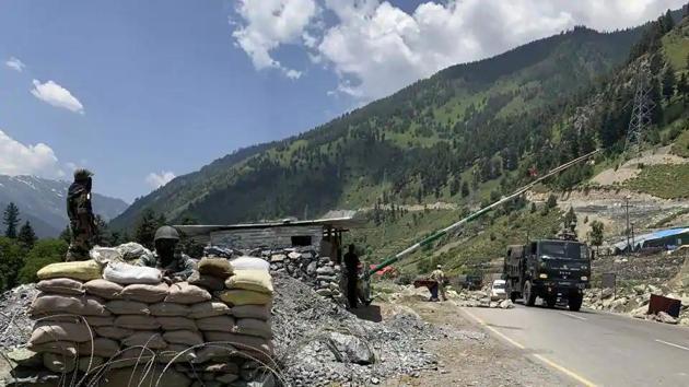 File photo: Indian paramilitary soldiers keep guard as Indian army convoy moves on the Srinagar- Ladakh highway at Gagangeer, north-east of Srinagar, India,(AP)