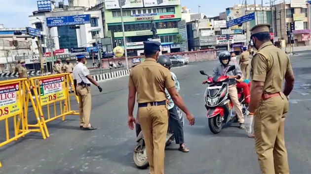 Police officers check the documents of a biker in Chennai during the ‘maximised restricted lockdown’, June 19, 2020.(PTI File)