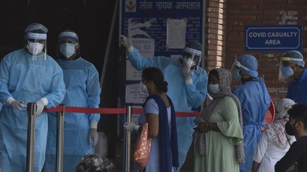 Medical staff interact with visitors outside the Covid-19 ward at Lok Nayak hospital on Saturday. (Sanjeev Verma/HT PHOTO) Medical staff interact with visitors outside the Covid-19 ward at Lok Nayak hospital on Saturday. (Sanjeev Verma/HT PHOTO)