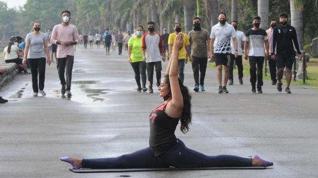A girl performing an asana on International Yoga Day at Sukhna Lake, as weather took a pleasant turn after overnight rain in Chandigarh on Sunday. (Keshav Singh/HT) A girl performing an asana on International Yoga Day at Sukhna Lake, as weather took a pleasant turn after overnight rain in Chandigarh on Sunday. (Keshav Singh/HT)