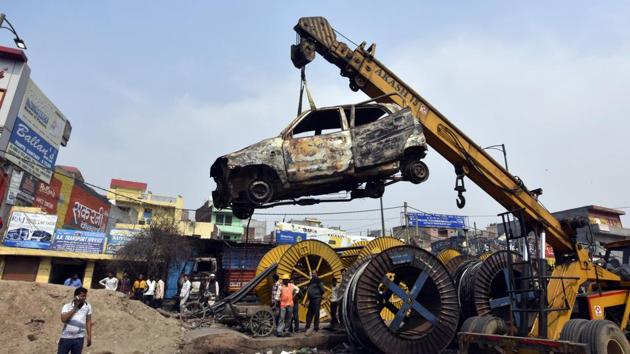 Charred vehicles are carried using a crane following violent clashes in North East Delhi over the new citizenship law, at Chand Bagh, in New Delhi. (Sonu Mehta/HT File PHOTO) Charred vehicles are carried using a crane following violent clashes in North East Delhi over the new citizenship law, at Chand Bagh, in New Delhi. (Sonu Mehta/HT File PHOTO)