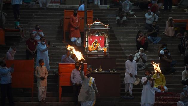 Priests perform evening prayers at Har Ki Pauri ghat on the banks of river Ganga, after the government eased a nationwide lockdown imposed as a preventive measure against coronavirus disease, at Haridwar in Uttarakhand. (AFP) Priests perform evening prayers at Har Ki Pauri ghat on the banks of river Ganga, after the government eased a nationwide lockdown imposed as a preventive measure against coronavirus disease, at Haridwar in Uttarakhand. (AFP)