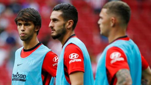 Atletico Madrid's Joao Felix, Koke and Kieran Trippier during the warm up before the match.(REUTERS)