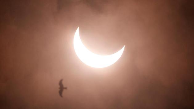 A partial solar eclipse is seen from Rajpath in New Delhi, India.(REUTERS)