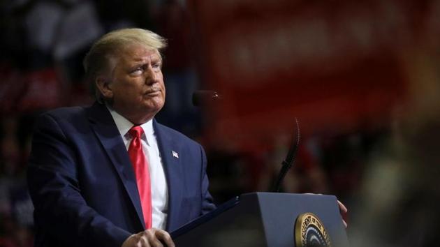 US President Donald Trump stands at the podium listening to his supporters cheer as he addresses his first re-election campaign rally in several months in the midst of the coronavirus disease (Covid-19) outbreak, at the BOK Center in Tulsa. (REUTERS) US President Donald Trump stands at the podium listening to his supporters cheer as he addresses his first re-election campaign rally in several months in the midst of the coronavirus disease (Covid-19) outbreak, at the BOK Center in Tulsa. (REUTERS)