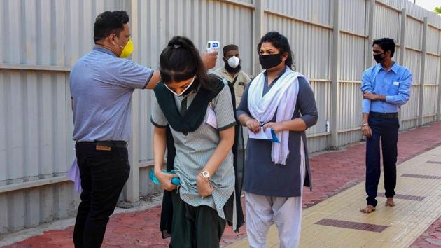 Students undergo thermal screening before entering examination hall during the MP Board exams recently. The state’s Covid-19 tally neared 12,000-mark on June 21, 2020, (PTI File) Students undergo thermal screening before entering examination hall during the MP Board exams recently. The state’s Covid-19 tally neared 12,000-mark on June 21, 2020, (PTI File)