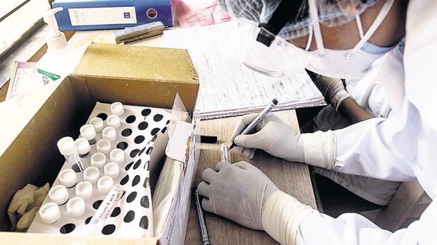 A health worker of Pune district council prepares to collect swabs at a Covid-19 swab collection centre, BJS hostel, Wagholi. (Pratham Gokhale/HT Photo) A health worker of Pune district council prepares to collect swabs at a Covid-19 swab collection centre, BJS hostel, Wagholi. (Pratham Gokhale/HT Photo)