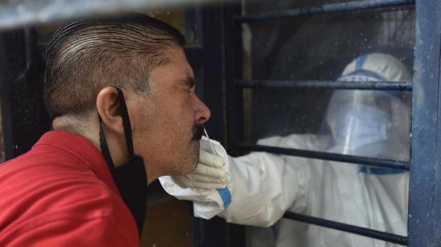 A medic collects swab sample from a man to test for Covid-19 infection at Gandhi Nagar in New Delhi on Sunday.(Sonu Mehta/HT PHOTO) A medic collects swab sample from a man to test for Covid-19 infection at Gandhi Nagar in New Delhi on Sunday.(Sonu Mehta/HT PHOTO)