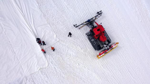 On the border between the Lombardy and Trentino Alto Adige regions, workers unroll the sheets in long strips, covering an area at an altitude of 2700 to 3000 metres. The Austrian-made tarps cost up to 400 euros ($450) each and it takes the team six weeks to install them -- and another six weeks to remove them before winter sets in again. (Miguel Medina / AFP) On the border between the Lombardy and Trentino Alto Adige regions, workers unroll the sheets in long strips, covering an area at an altitude of 2700 to 3000 metres. The Austrian-made tarps cost up to 400 euros ($450) each and it takes the team six weeks to install them -- and another six weeks to remove them before winter sets in again. (Miguel Medina / AFP)