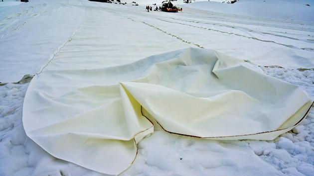 A huge sheet put up on the Presena glacier, in order to delay snow melting on skiing slopes. “The coverings are geotextile tarpaulins that reflect sunlight, maintaining a temperature lower than the external one, and thus preserving as much snow as possible,” Panizza said. (Miguel Medina / AFP) A huge sheet put up on the Presena glacier, in order to delay snow melting on skiing slopes. “The coverings are geotextile tarpaulins that reflect sunlight, maintaining a temperature lower than the external one, and thus preserving as much snow as possible,” Panizza said. (Miguel Medina / AFP)