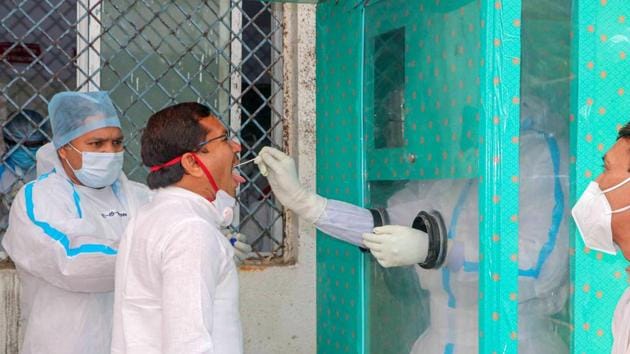 Medics collect swab sample of a BJP MLA for Covid-19 test at JP hospital, in Bhopal. (PTI) Medics collect swab sample of a BJP MLA for Covid-19 test at JP hospital, in Bhopal. (PTI)