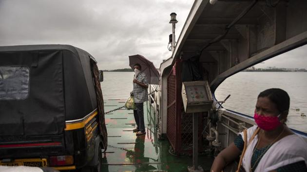 Commuters wearing masks as a precaution against the coronavirus travel in a ferry in Koch in Kerala. (AP) Commuters wearing masks as a precaution against the coronavirus travel in a ferry in Koch in Kerala. (AP)