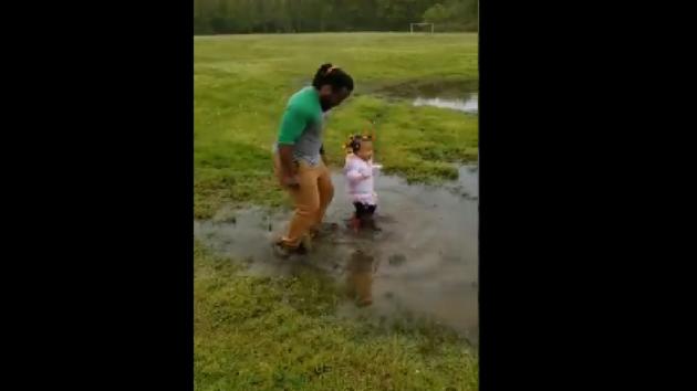 The clip shows the little girl convincing her dad to step inside a puddle.(Instagram/@jamesgymjones) The clip shows the little girl convincing her dad to step inside a puddle.(Instagram/@jamesgymjones)