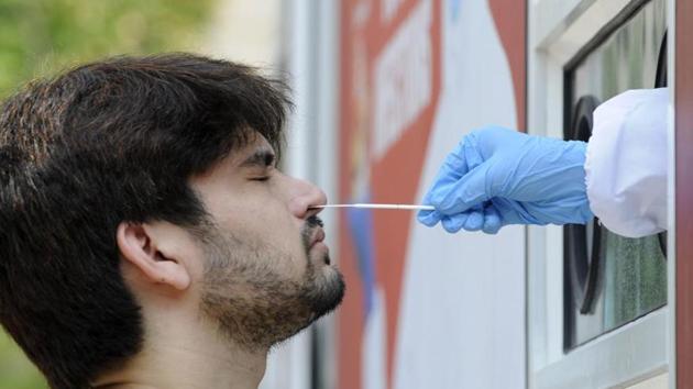 A person gives a swab sample for Covid-19 testing at the Sector 30 District hospital, in Noida. (Sunil Ghosh / Hindustan Times) A person gives a swab sample for Covid-19 testing at the Sector 30 District hospital, in Noida. (Sunil Ghosh / Hindustan Times)