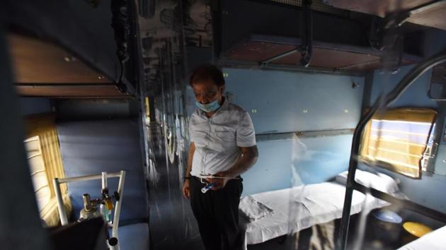 An Indian Railways staff notes down details inside a train coach--temporarily converted into an isolation ward for coronavirus patients, at Anand Vihar railway station in New Delhi on Saturday.(Raj K Raj/HT Photo) An Indian Railways staff notes down details inside a train coach--temporarily converted into an isolation ward for coronavirus patients, at Anand Vihar railway station in New Delhi on Saturday.(Raj K Raj/HT Photo)