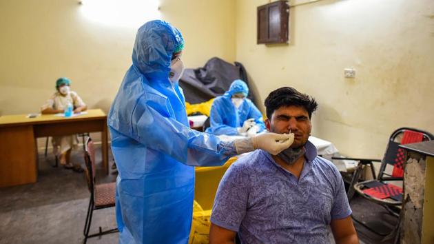 A health worker in PPE takes a swab sample from a person for COVID-19 antigen testing in Lado Sarai on June 22. A serological survey of Delhi is to be conducted between June 27 and July 10, and 20,000 samples will be collected to analyse the scale of the spread of Covid-19. (Amal KS / HT Photo) A health worker in PPE takes a swab sample from a person for COVID-19 antigen testing in Lado Sarai on June 22. A serological survey of Delhi is to be conducted between June 27 and July 10, and 20,000 samples will be collected to analyse the scale of the spread of Covid-19. (Amal KS / HT Photo)