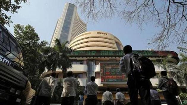 People look at a screen displaying the Sensex results on the facade of the Bombay Stock Exchange (BSE) building in Mumbai (REUTERS) People look at a screen displaying the Sensex results on the facade of the Bombay Stock Exchange (BSE) building in Mumbai (REUTERS)