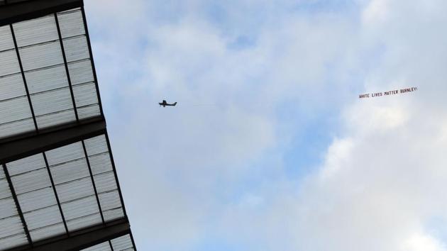 A plane towing a banner reading 'White Lives Matter Burnley' is seen in the sky. (AFP) A plane towing a banner reading 'White Lives Matter Burnley' is seen in the sky. (AFP)
