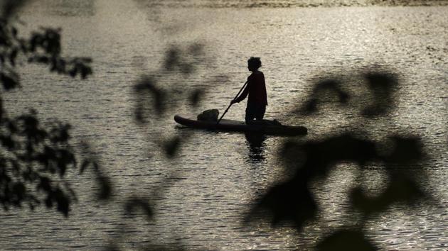 A woman paddles across the Landwehrkanal during sunset on Summer Solstice, the longest day of the year in Berlin, Germany, Sunday, June 21, 2020. (AP Photo/Markus Schreiber) A woman paddles across the Landwehrkanal during sunset on Summer Solstice, the longest day of the year in Berlin, Germany, Sunday, June 21, 2020. (AP Photo/Markus Schreiber)
