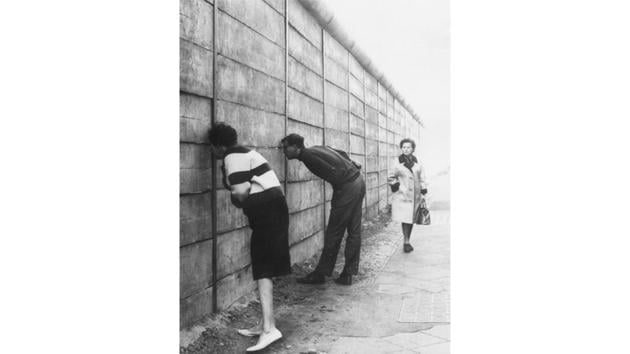 West Berliners peer through the Berlin Wall into the Eastern sector near Check Point Charlie, c. 1966. Checkpoint Charlie was the site of various daring attempts by East Germans to escape to the West, since it was one of the only gaps in the mass of concrete and barbed wire that made up the Berlin Wall. (Keystone / Getty Images) West Berliners peer through the Berlin Wall into the Eastern sector near Check Point Charlie, c. 1966. Checkpoint Charlie was the site of various daring attempts by East Germans to escape to the West, since it was one of the only gaps in the mass of concrete and barbed wire that made up the Berlin Wall. (Keystone / Getty Images)