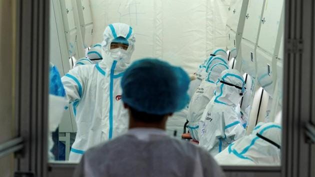 Staff members in protective suits work inside a mobile laboratory for nucleic acid testing, at a sports centre in Daxing district following a new outbreak of the coronavirus disease (COVID-19) in Beijing, China June 23, 2020.(REUTERS)